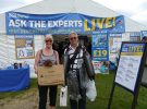 Bernie and Mike Wrankmore and miniature dachshound Elsa outside the PBO Ask the Experts Live marquee