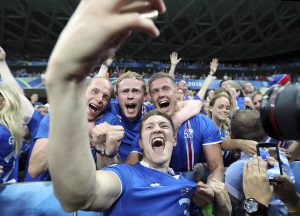 Iceland's Haukur Heidar Hauksson takes a selfie with supporters at the end of the win against England in Nice.
