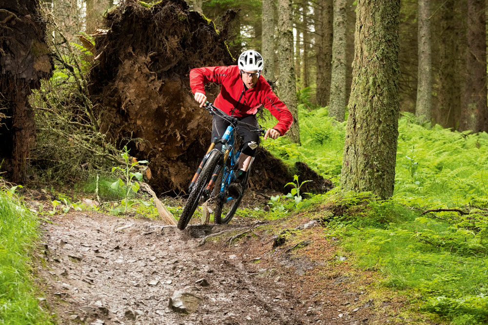 Here Andy keeps his body position low so that when his bike starts to hit the looser trail further down he still has room to let it move underneath him.
