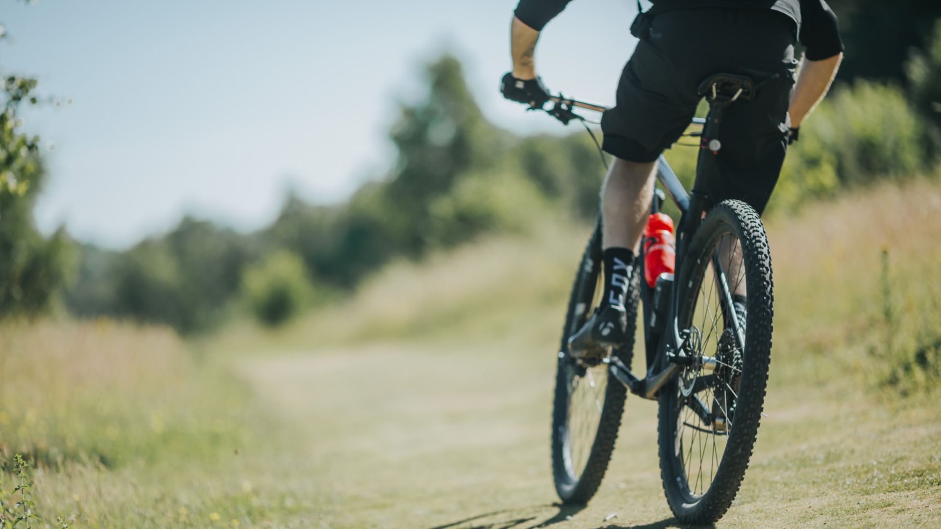 Image of mountain biker on gravel path