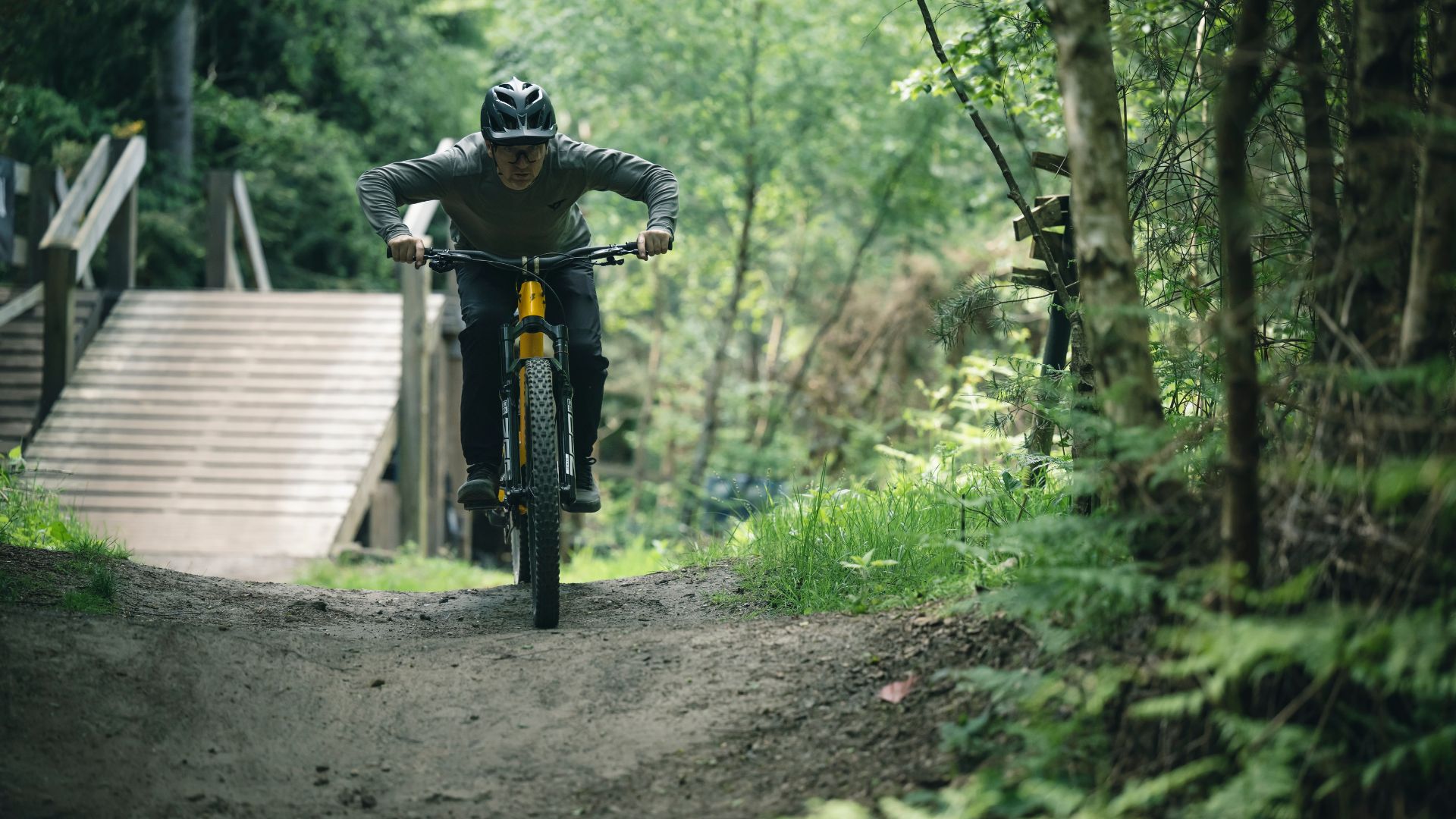 Man riding mountain bike with level pedals - essential bike park skills