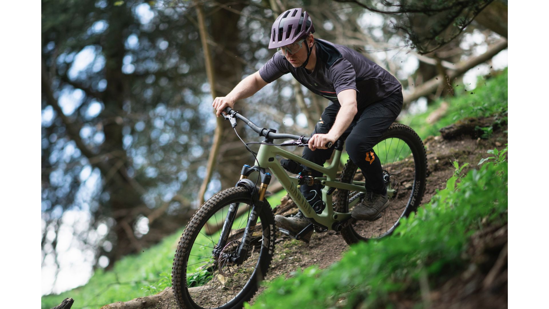 Man riding the Canyon Spectral 125 mountain bike on forest trails