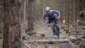 Man mountain biking on a Cube hardtail MTB on forest trails