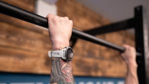 Mans hand photographed hanging to a bar