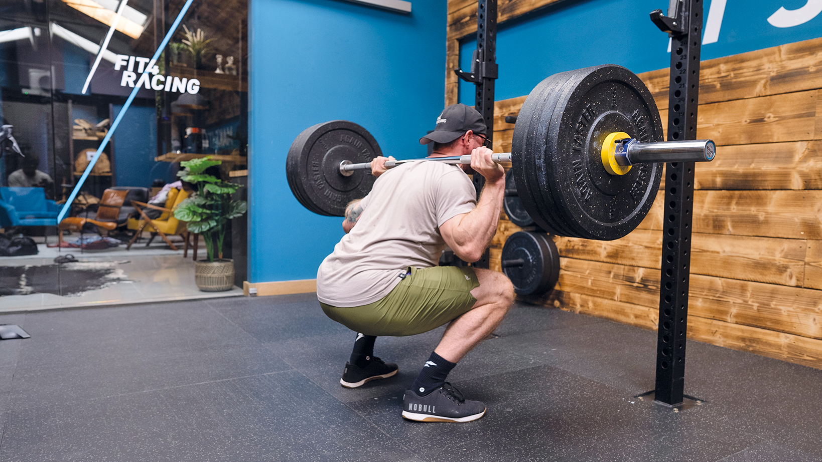 Man squatting with weights