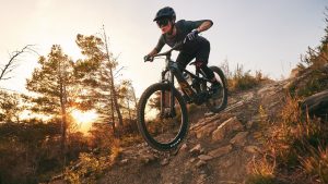 Woman riding Liv Intrigue X Advanced E+ Elite electric mountain bike