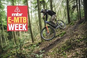 Rider jumping e-bike in the woods