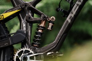 EXT Storia coil shock catches the sunlight on a Devinci mountain bike