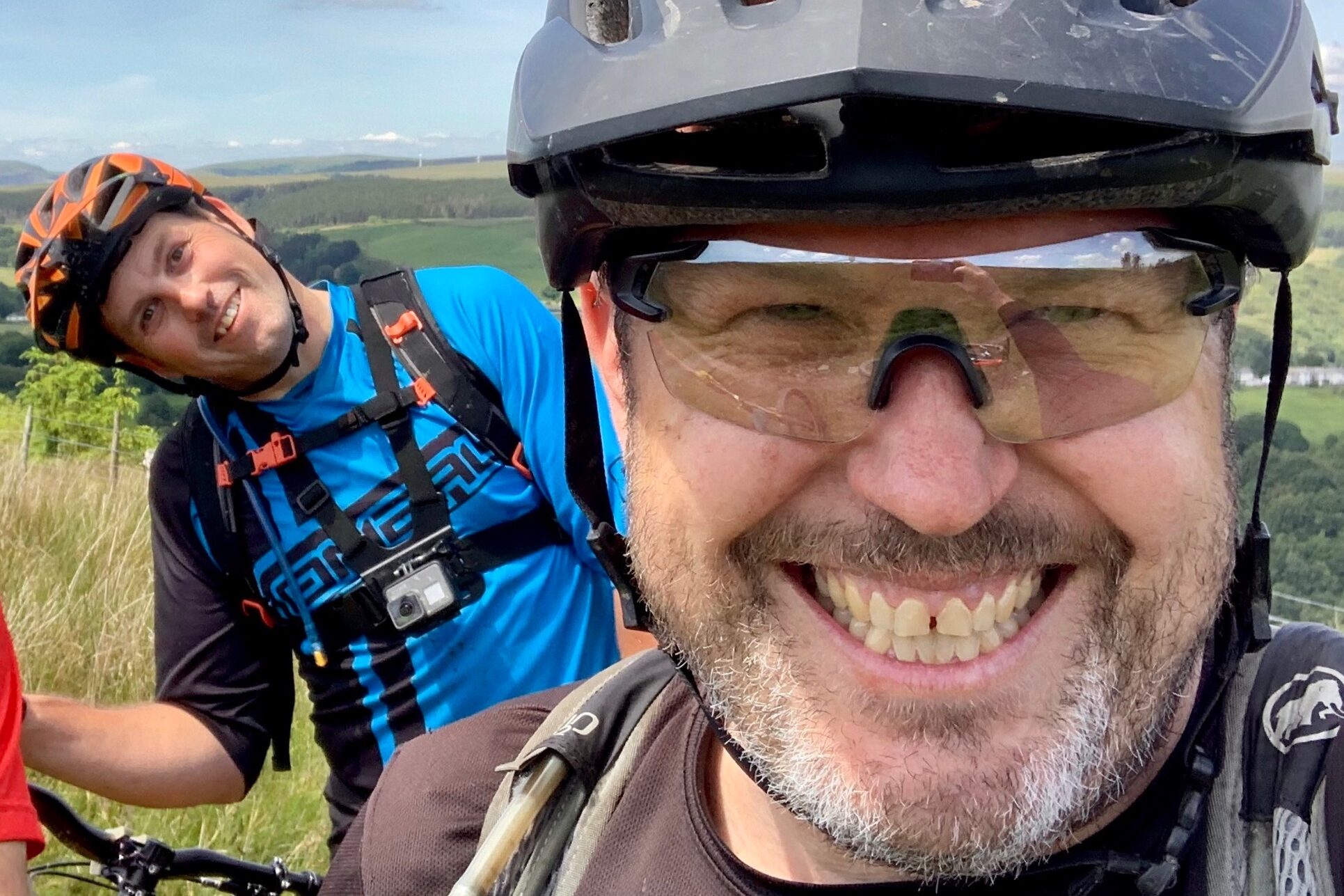 UK MTB Trail Alliance founder Robin Grant at the top of a hill wearing a mountain bike helmet