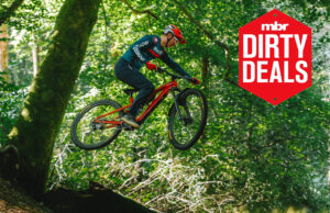 The Trek Fuel EXe 9.7 airborne with the MBR dirty deals logo