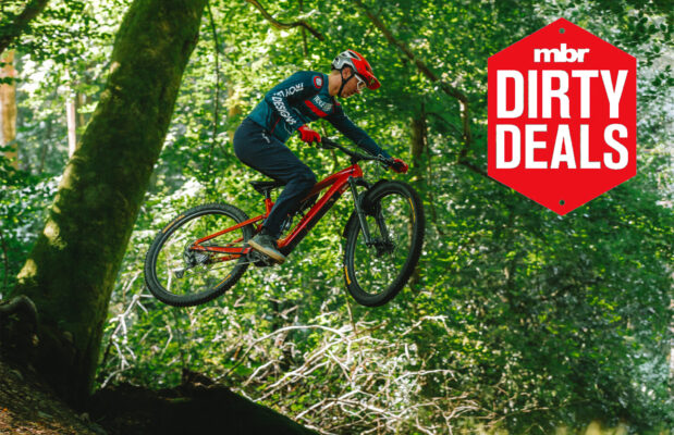 The Trek Fuel EXe 9.7 airborne with the MBR dirty deals logo