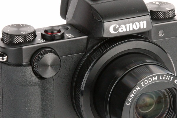 A dial on the front and ring around the lens are used to change key settings