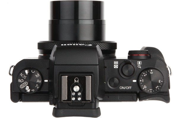 The top plate hosts exposure mode and exposure compensation dials