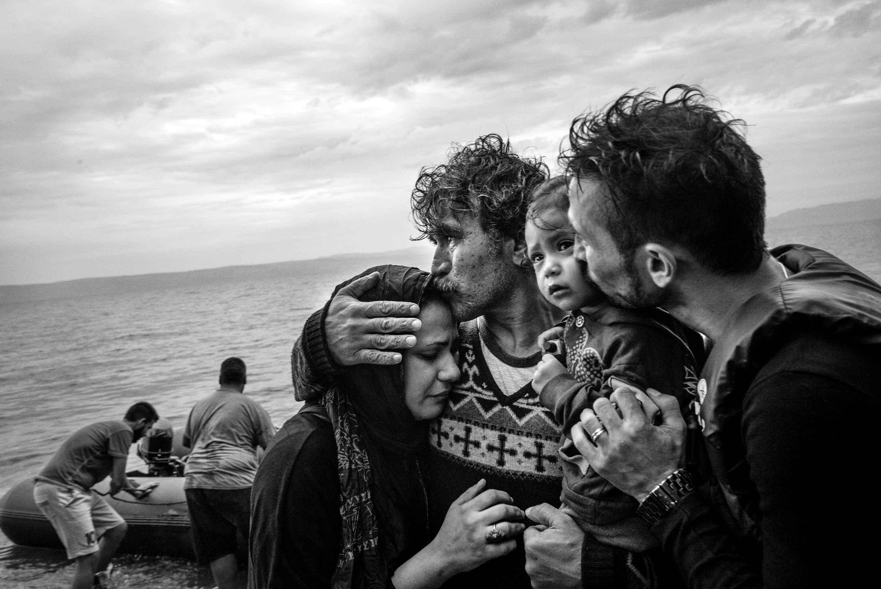 A Syrian family weeps tears of joy after reaching, on a rubber boat from Turkey, the village of Skala Sykaminias located on the northeastern Greek island of Lesbos, on October 10, 2015. Thousand of refugees, mostly coming from Syria, Iraq and Afghanistan, cross everyday the Aegean sea from Turkey to reach Europe: a relatively short but extremely perilous journey. According to the UN Refugee Agency, more than 850 000 arrivals by sea were registered in Greece in 2015.