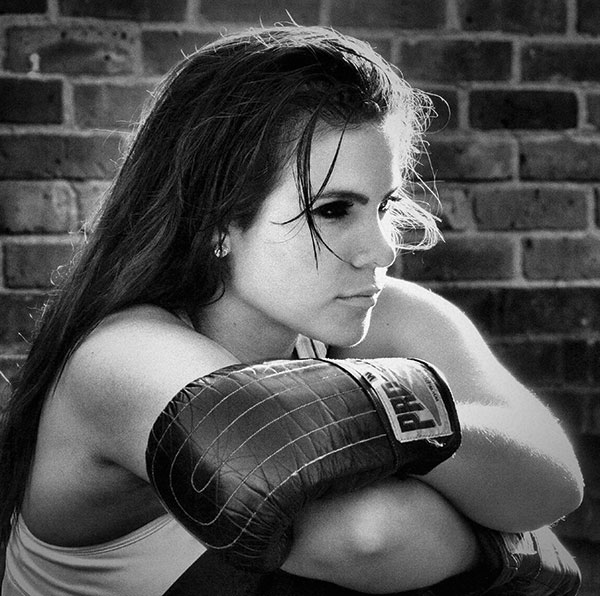 Before: The level of contrast has darkened the boxer's eyes and burnt out the highlights on her arm