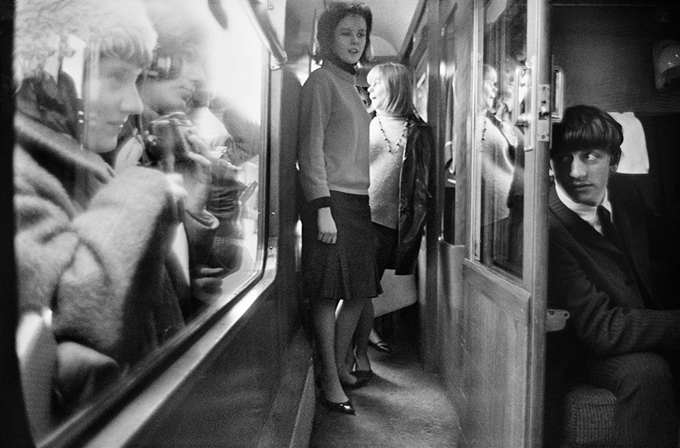 G.B. ENGLAND. LONDON. The BEATLES during filming of 'A Hard Days Night'. The Beatles film was primarily shot on a moving train. Fans eying Ringo Starr. 1964.