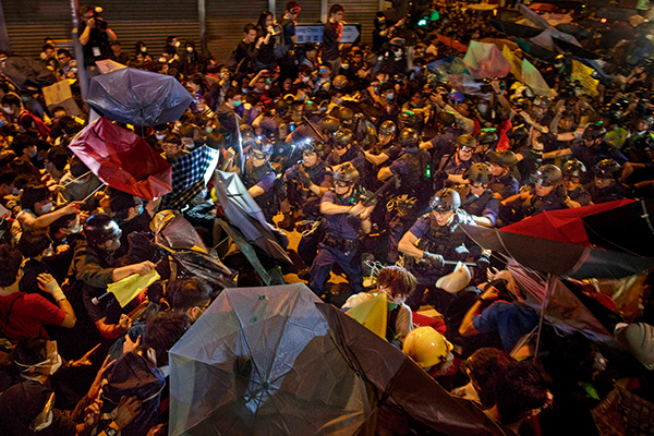 Protesters clash with police during a night of confrontation in the Mong Kok district of Hong Kong on 25 November 2014