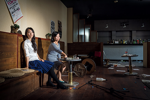 The normality of the subjects’ poses belies the devastation around them
