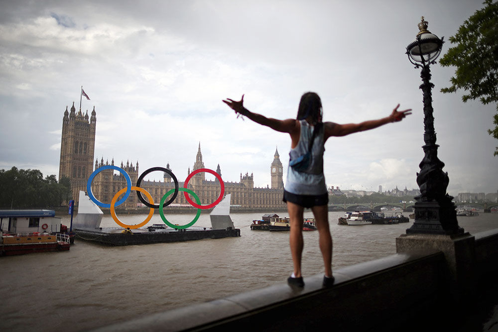 Peter Macdiarmid Olympic rings float on barge opposite parliament