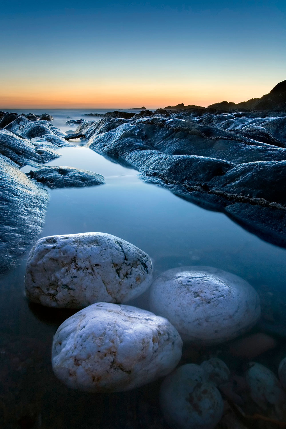 low-light sunset at butter cove, bantham, devon