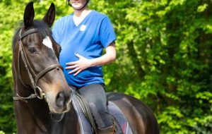 pregnant lady riding a horse