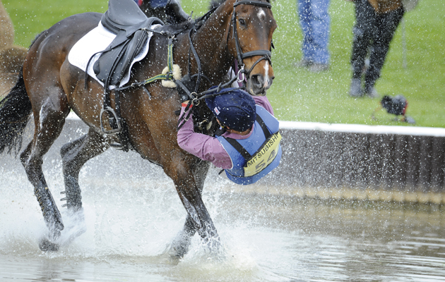Cross Country . James Robinson and Comanche take a rather wet fall . Comanche has other ideas about continuing the trial !