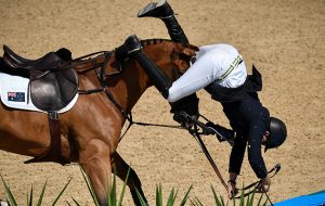 Australia's Scott Keach falls during the 2nd round of the equestrian's jumping individual and team qualifier event of the Rio 2016 Olympic Games at the Olympic Equestrian Centre in Rio de Janeiro on August 16, 2016. / AFP / PHILIPPE LOPEZ (Photo credit should read PHILIPPE LOPEZ/AFP/Getty Images)