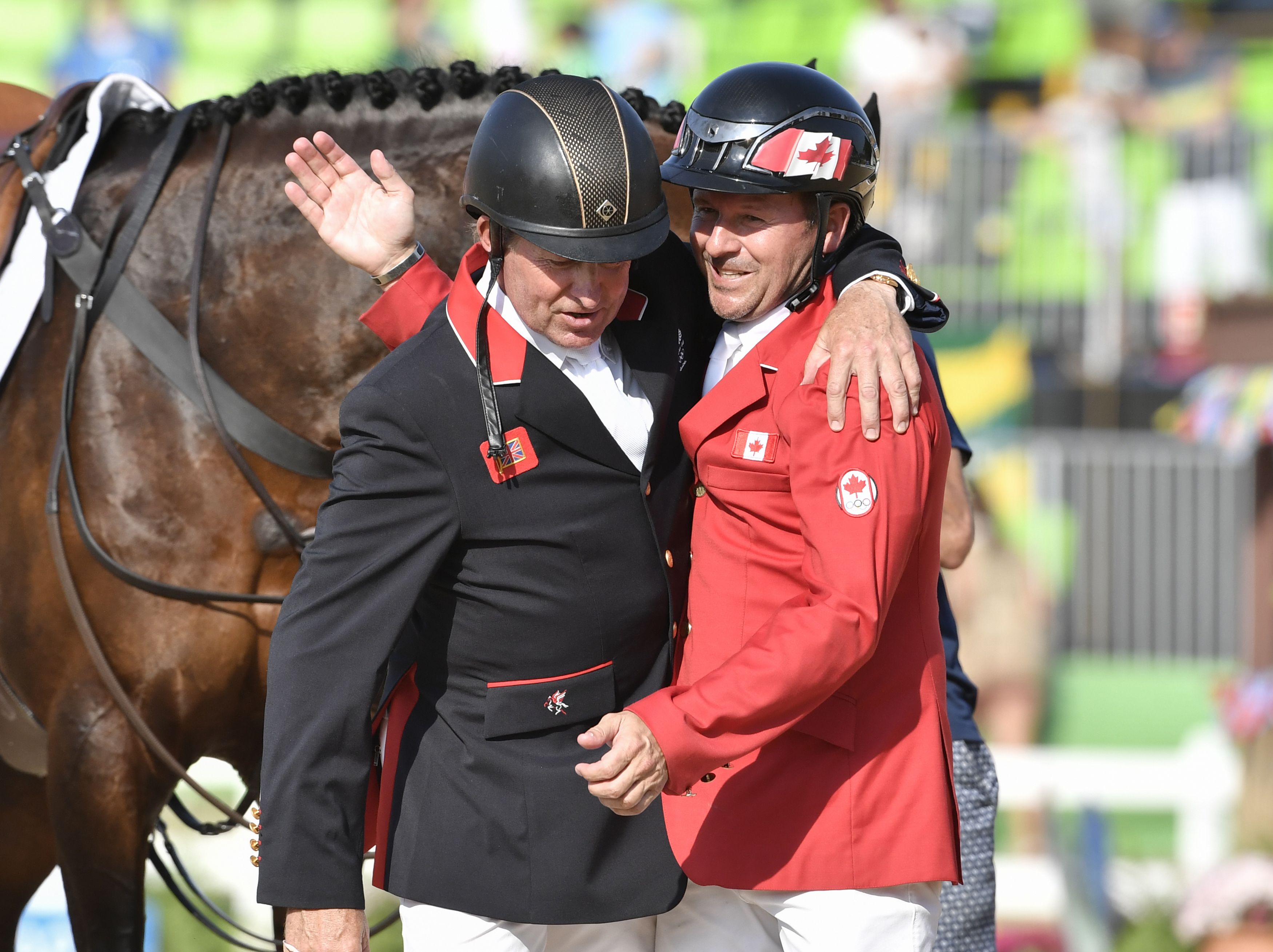 Canada's Eric Lamaze (R) and Britain's Nick Skelton greet each other after the final round of the individual equestrian show jumping event at the Olympic Equestrian Centre during the Rio 2016 Olympic Games in Rio de Janeiro on August 19, 2016.