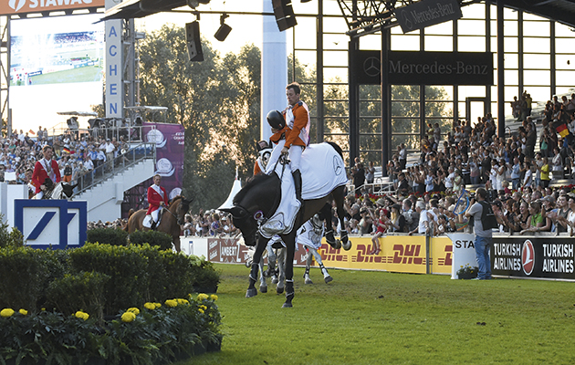 The winning Dutch team on their lap of honour ; Jeroen DUBBELDAM (NED) riding SFN Zenith N.O.P., Maikel VAN DER VLEUTEN (NED) riding VDL Groep Verdi Tn N.O.P., Jur VRIELING (NED) riding VDL Zirocco Blue N.O.P. and Gerco SCHRÖDER (NED) riding Glock's Cognac Champblanc at the European Team Jumping competition at the FEI European Championships in Aachen, Germany on 21 August 2015