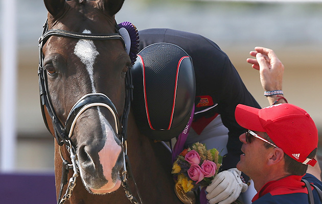 LONDON, ENGLAND - AUGUST 09: Charlotte Dujardin of Great Britain riding Valegro celebrates with her gold medal during the medal ceremony following the Individual Dressage on Day 13 of the London 2012 Olympic Games at Greenwich Park on August 9, 2012 in London, England. (Photo by Alex Livesey/Getty Images)