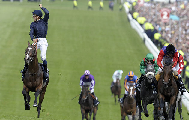 French jockey Mickael Barzalona riding Pour Moi (left) comes up the finishing hill to win the Investec Derby race ahead of Treasure Beach (ridden by Colin O'Donoghue) and the favourite Carlton House (ridden by Ryan Moore) in third place to give France its first Derby win in 35 years at Epsom Downs racecourse on 4th June 2011. (Photo by Leo Mason/Popperfoto/Getty Images)