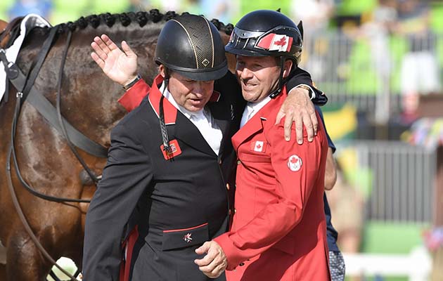 Canada's Eric Lamaze (R) and Britain's Nick Skelton greet each other after the final round of the individual equestrian show jumping event at the Olympic Equestrian Centre during the Rio 2016 Olympic Games in Rio de Janeiro on August 19, 2016. Skelton riding Big Star won the individual show jumping gold. / AFP / John MACDOUGALL (Photo credit should read JOHN MACDOUGALL/AFP/Getty Images)