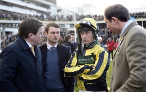 Jockey Nico de Boinville is a picture of concentration in the paddock, with connections, including the owners manager, former top jockey, Jason Maguire (left) 1-1-18