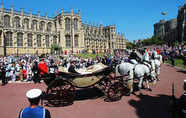 WINDSOR, ENGLAND - MAY 19:  Prince Harry, Duke of Sussex and the Duchess of Sussex in the Ascot Landau carriage during the procession after getting married St George's Chapel, Windsor Castle on May 19, 2018 in Windsor, England.  (Photo by Chris Jackson/Getty Images)
