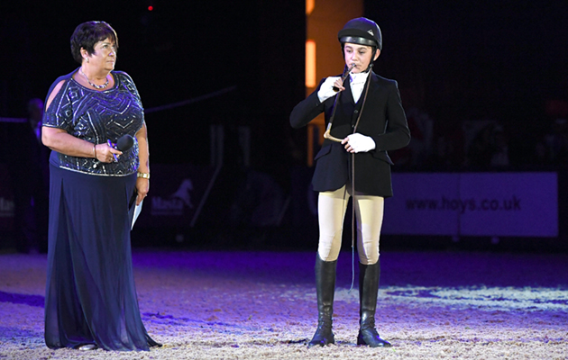 Sam Walker blowing a hunting horn in memory of ?? at the Horse of The Year Show 2018 at the NEC near Birmingham in the UK between 2nd- 7th October 2018