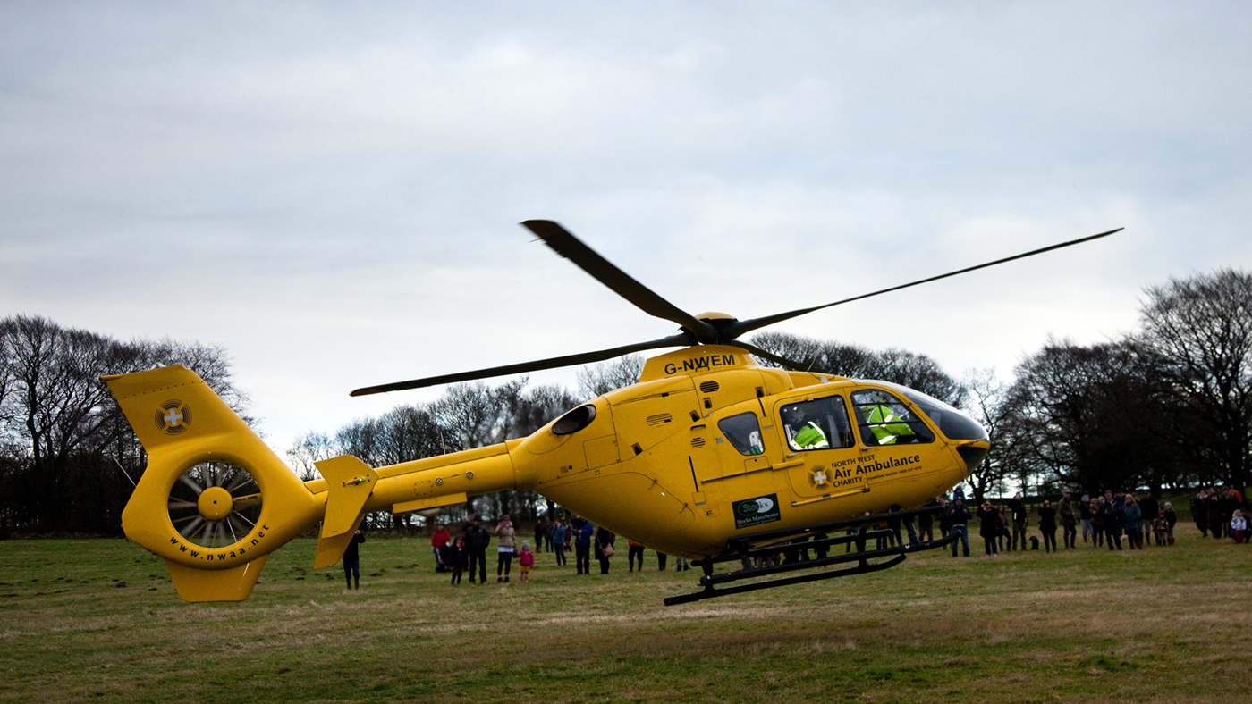 Air ambulance tips D1K105 G-NWEM. Eurocopter EC135T2 at Horwich near Bolton, Lancashire Wednesday 26th December, 2012: North West Air Ambulance Charity helicopter attends injured female spectator, who had been kicked in the head by a horse, in a field at Rivington where the Holcombe hunt gathered for a Boxing Day event.