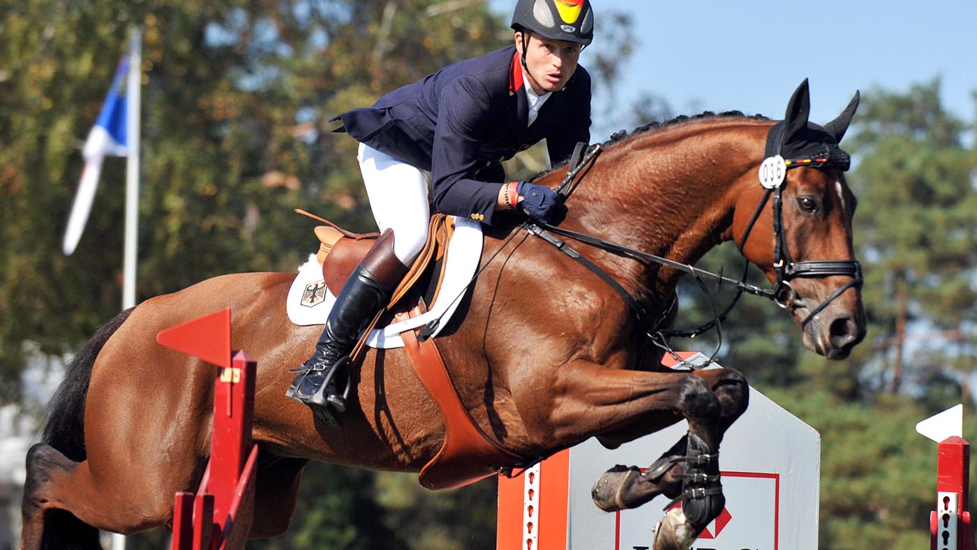 German Michael Jung (third placed) jumps with Sam on September 27, 2009 in Fontainebleau, east of Paris, during the European Equestrian jumping championship. AFP PHOTO MIGUEL MEDINA (Photo credit should read MIGUEL MEDINA/AFP/Getty Images)