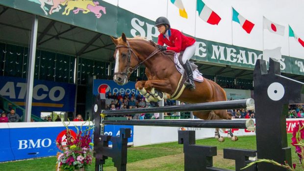 Beezie Madden jumping at Spruce Meadows