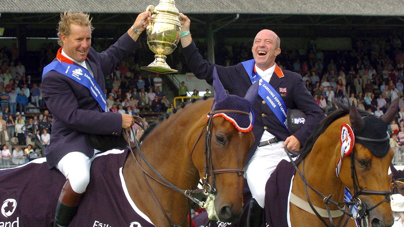 Great Britain's William Funnel (left) on Cortaflex Mondriaan, and Michael Whitaker on Portofino 63, hold up Aga Khan Challenge Trophy.