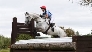 Charlotte Agnew pilots Jacobite across country in a Fairfax eventing breastplate