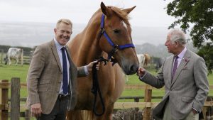 The Prince of Wales (right) is introduced to Victoria, a Suffolk Punch horse by farmer and television personality Adam Henson, during a visit to Cotswold Farm Park in Guiting Power near Cheltenham, to view the work the farm is doing in preserving British native breeds.