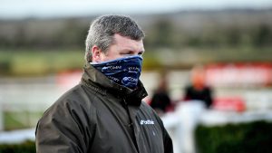 The British Horseracing Authority has temporarily banned Gordon Elliott from having runners in Britain, pending an investigation into a photo of him sitting on a dead horse