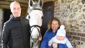 Tim Price with wife Jonelle Price and their son Otis at their stables in Wiltshire.