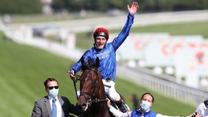Jockey Adam Kirby celebrates after winning the Cazoo Derby 2021 riding Adayar.