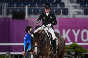 Isabell Werth pats Bella Rose 2 after their grand prix ride at the Tokyo Olympic dressage