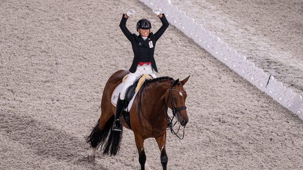 Belgium’s Michele George celebrates her super score in the individual grade V competition in the Tokyo Paralympic dressage
