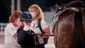 Natasha Baker gives a thumbs up at the grade III individual dressage medal ceremony at the Tokyo Paralympics.