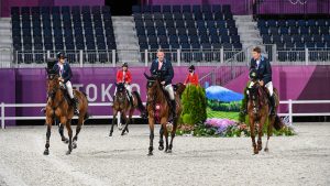 Sweden enjoy their lap of honour after winning gold in the Tokyo 2020 Olympic team showjumping