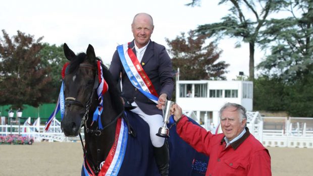 Adrian Speight and Millfield Baloney being congratulated on their British showjumping national championship win by David Broome