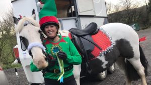 Leanne before the stroke with her horse Rio wearing Christmas fancy dress